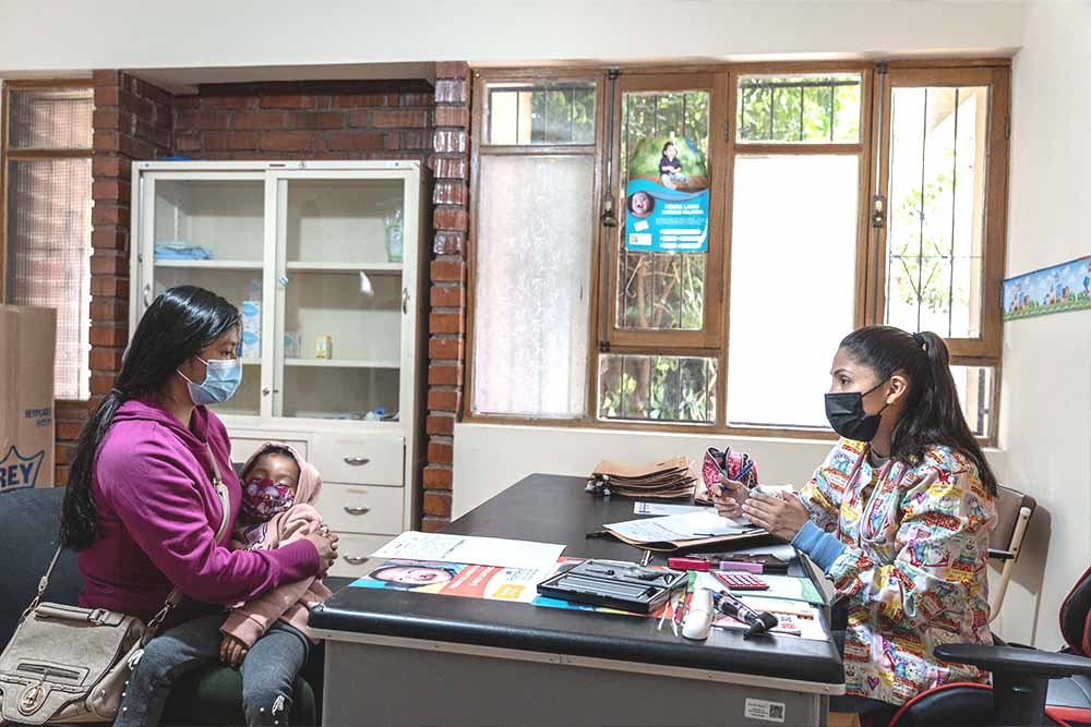 Mother meeting with Smile Train partner with her cleft-affected child