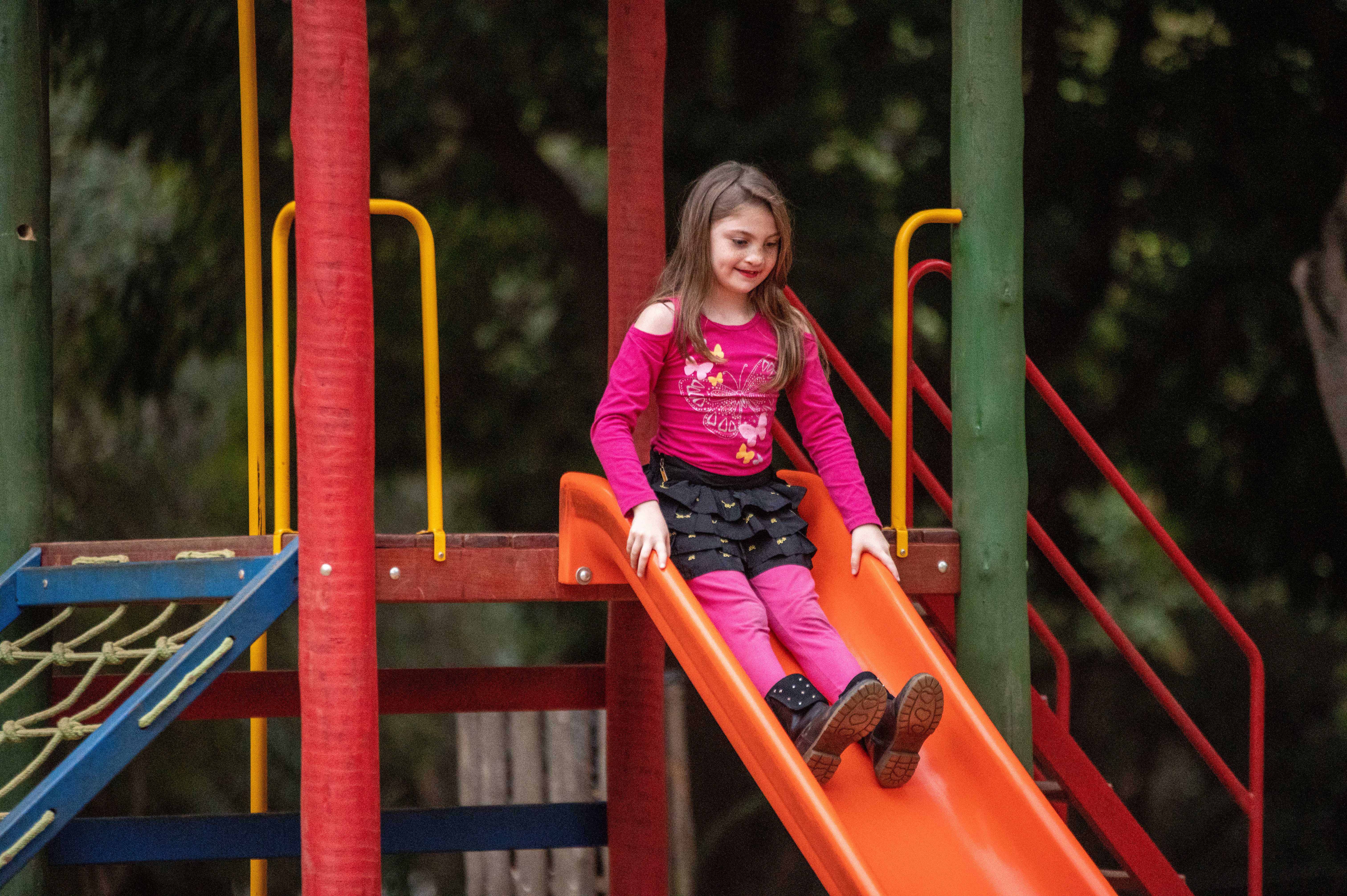 Milena sliding down a slide