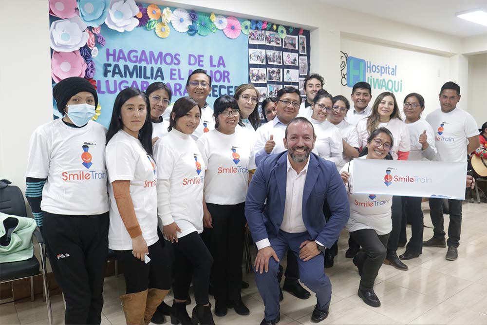 Iván poses with Smile Train patients and families in Bolivia