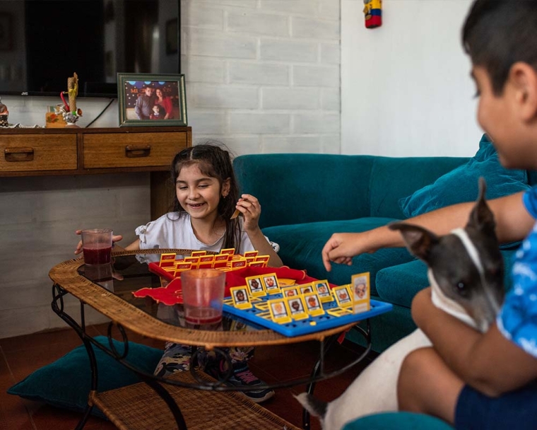 Aylen smiling and playing a board game after cleft surgery