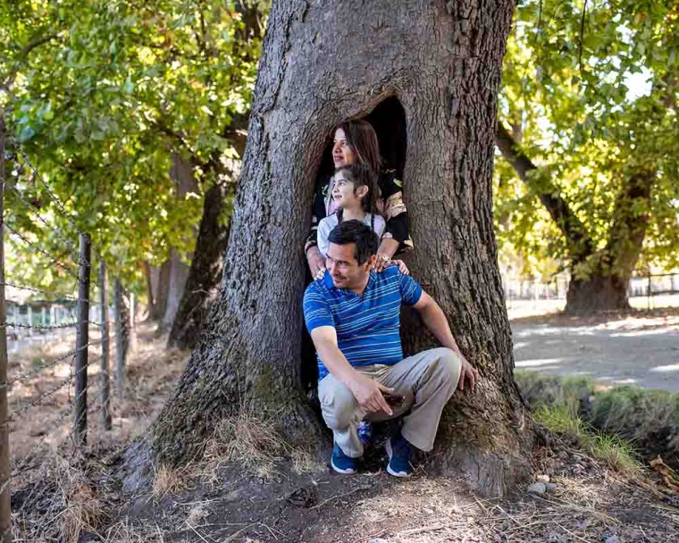 Aylen smiling and playing on a tree with her family after cleft surgery